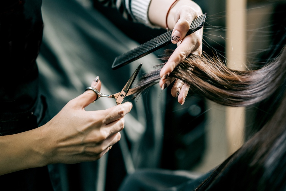 hair stylist cutting womens hair