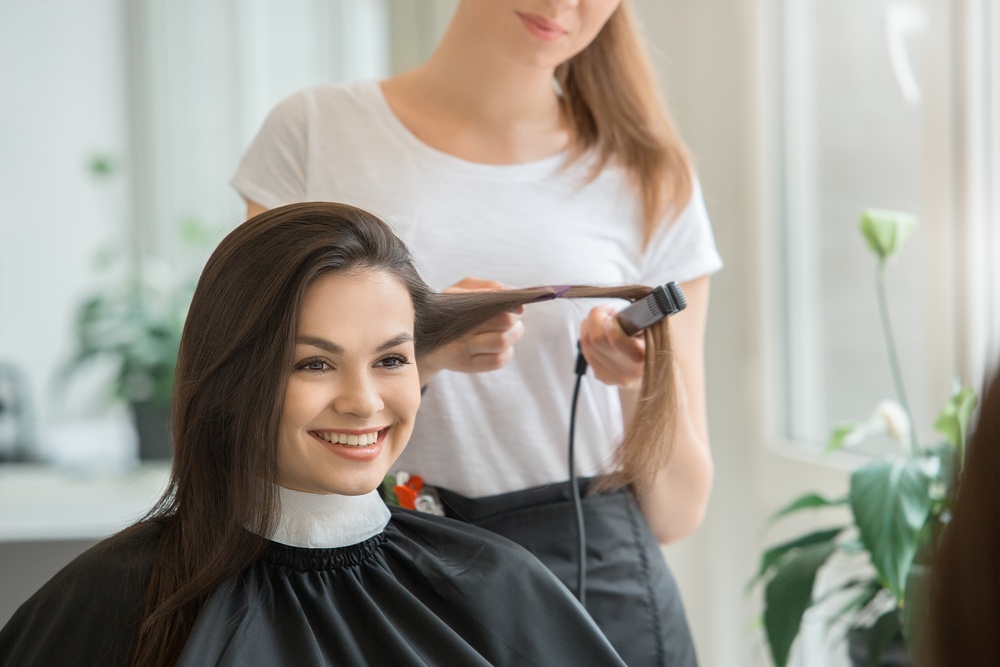 happy woman with hair stylist